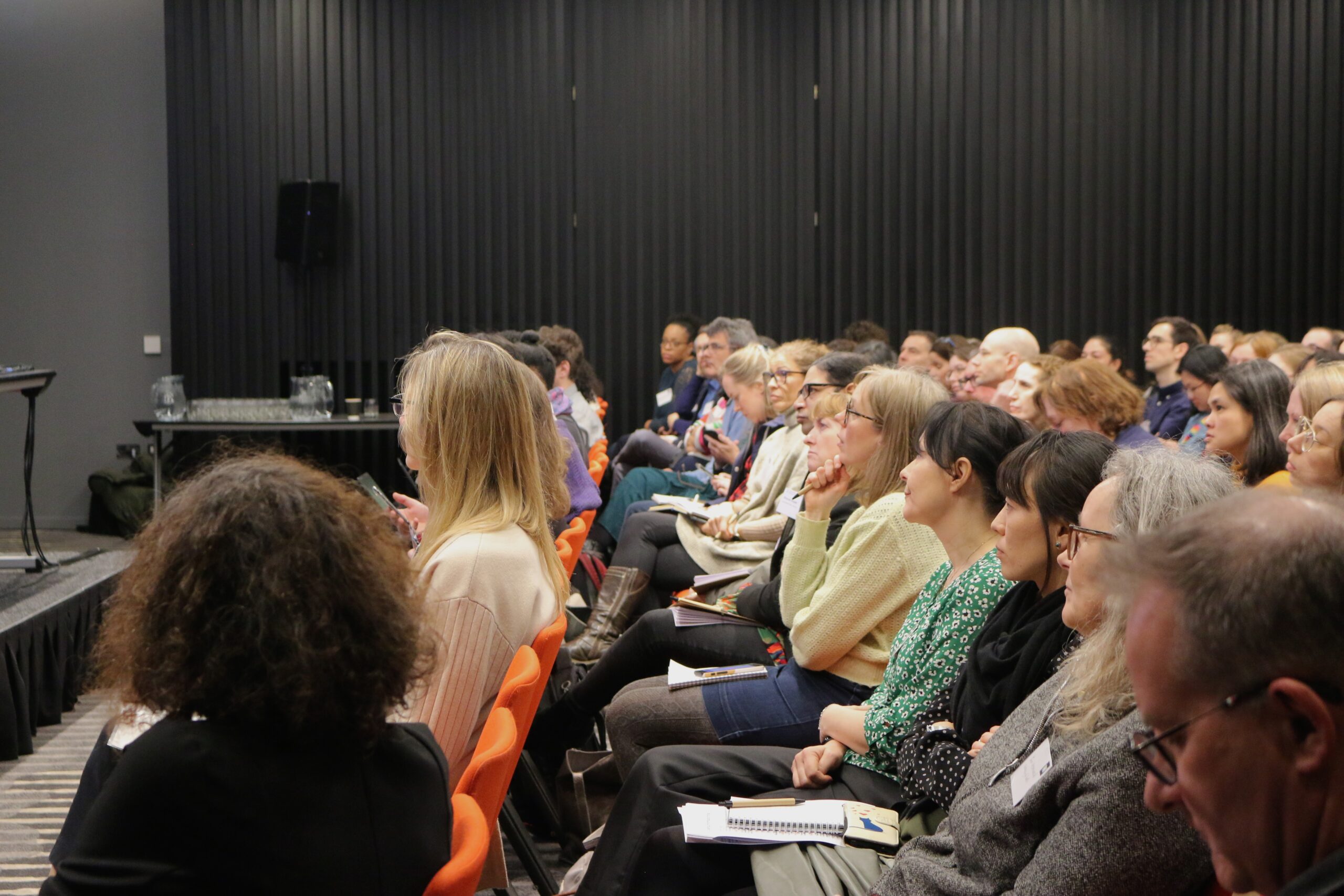 Attendees listen to presentation