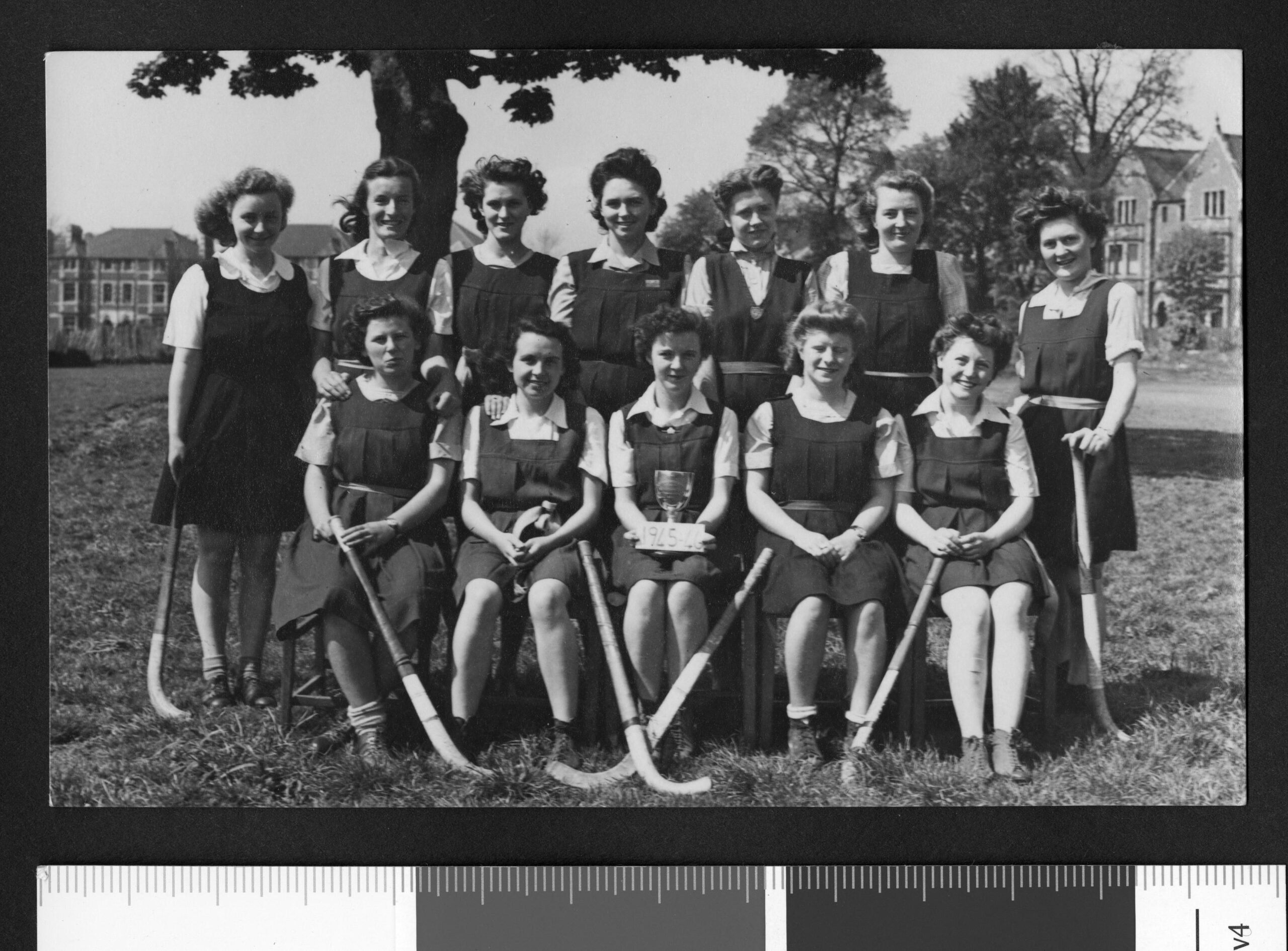 Ladies Hockey team 1945-46, lady in centre holding a trophy