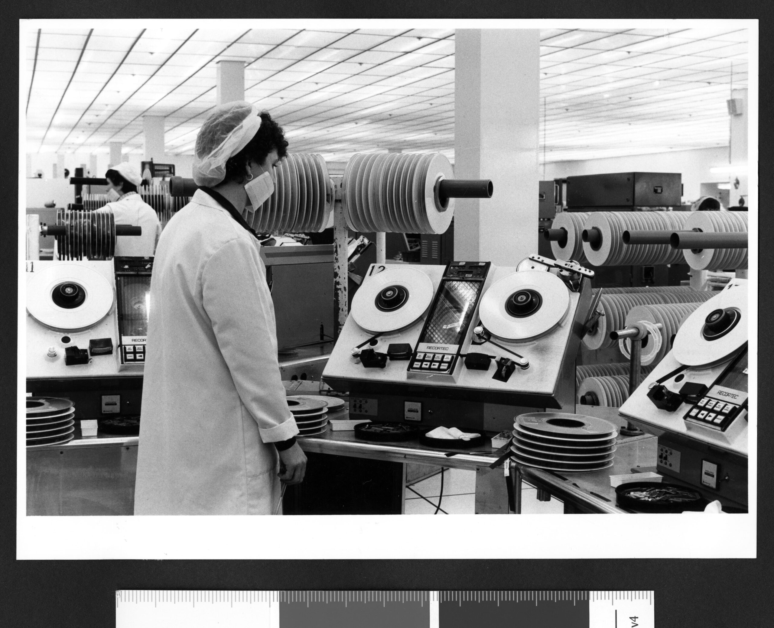 Technician operating Recortec magnetic tape equipment, 1980s