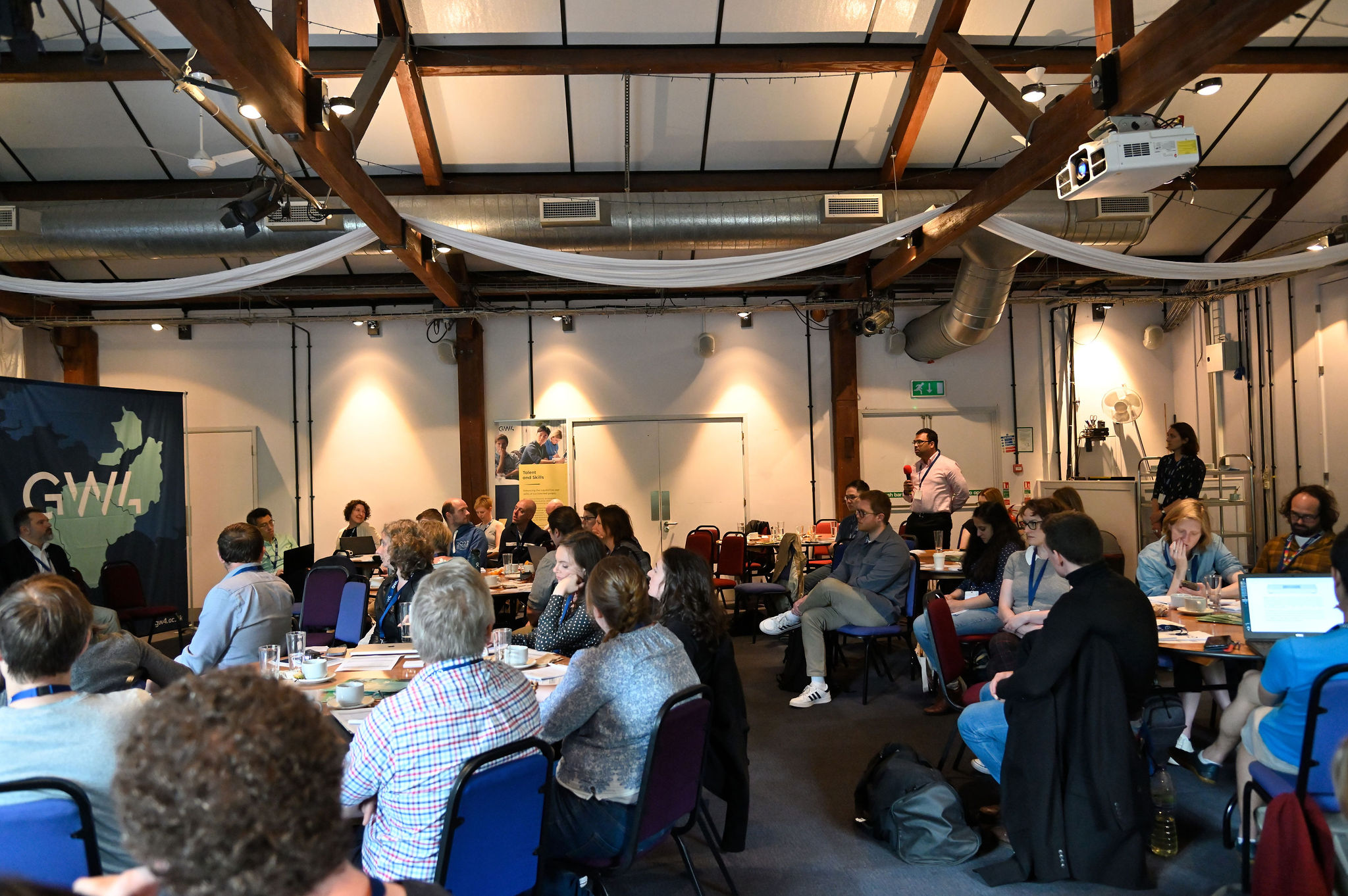 Attendees ask questions during workshop