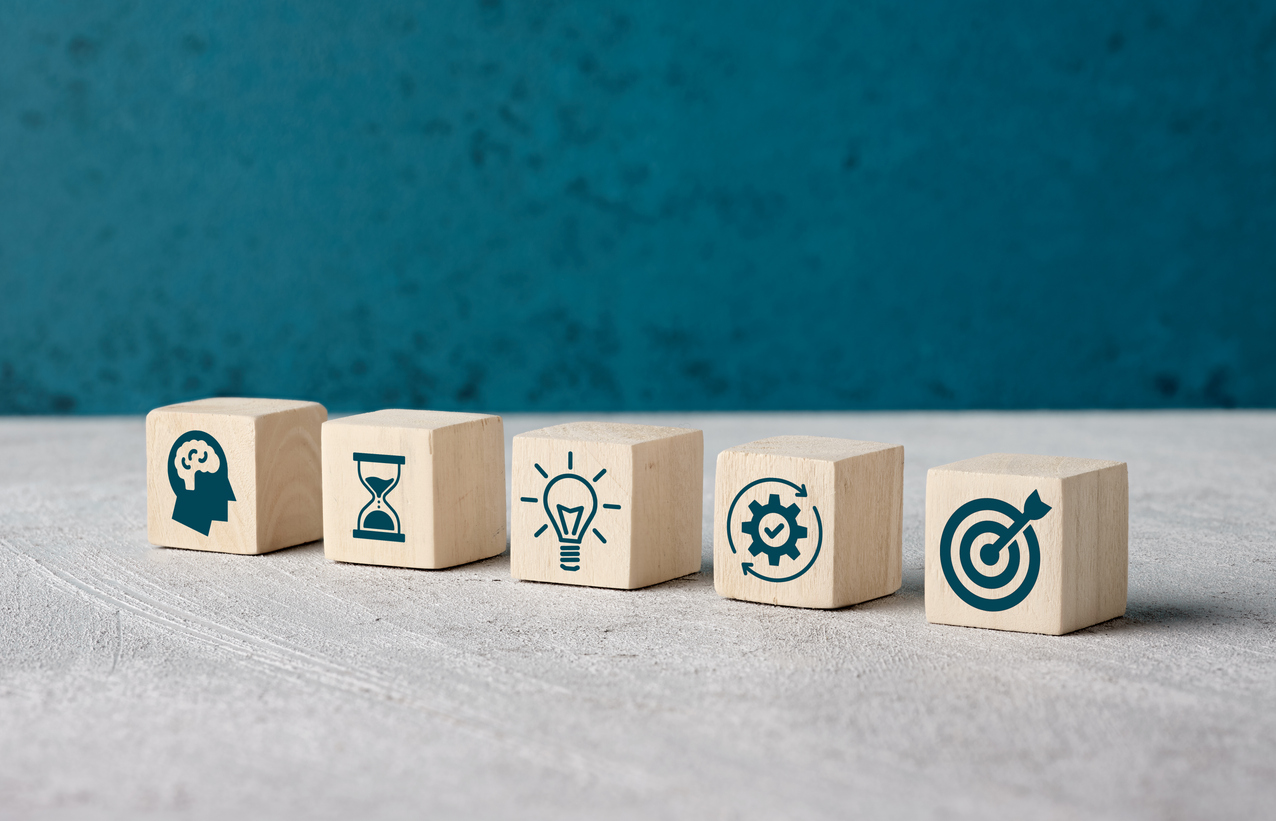 Wooden blocks with icons on them around idea generation.