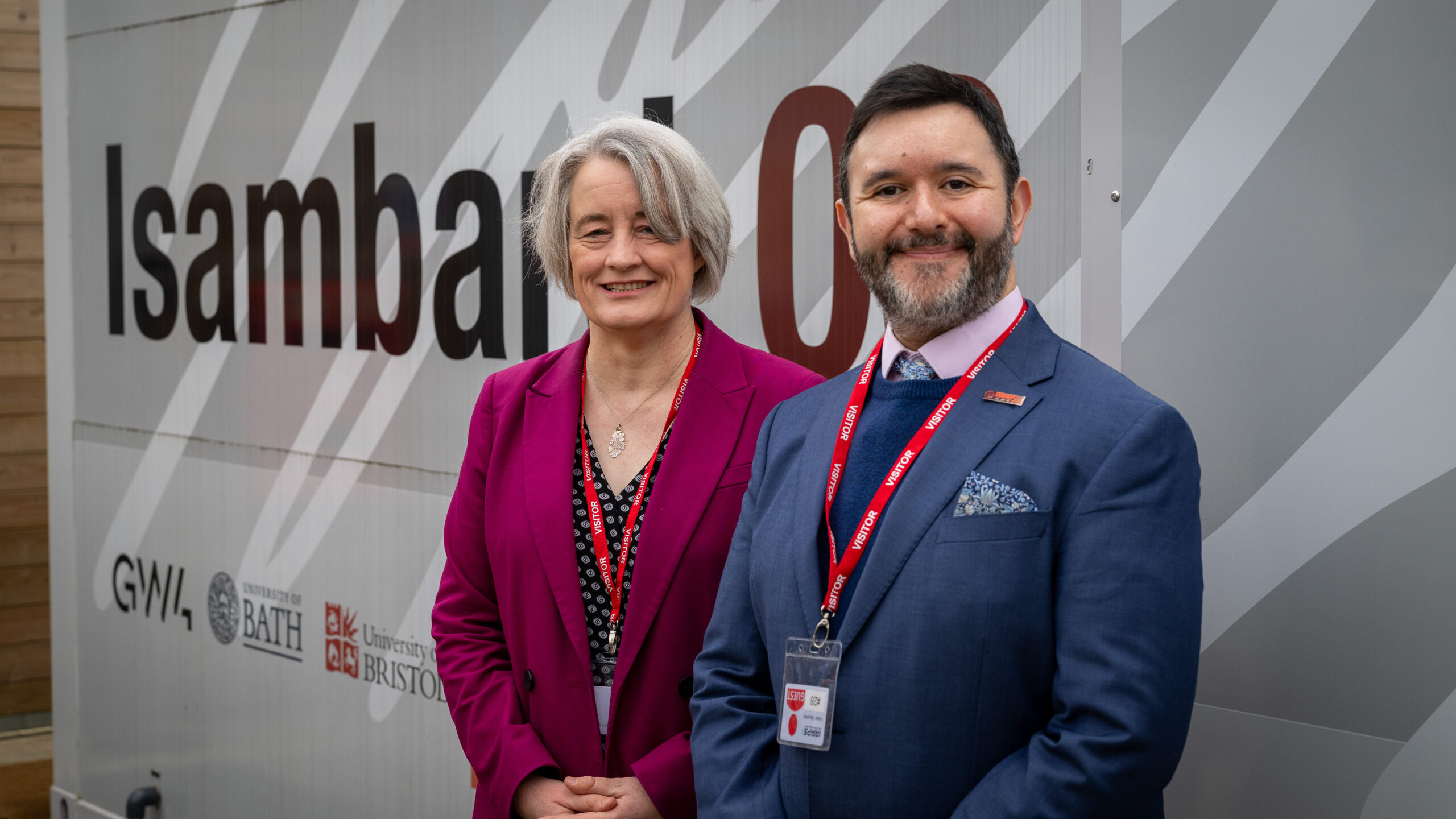 Claire Young MP (Thornbury & Yate) and Sadik Al-Hassan MP (North Somerset) standing outside in front of GW4 supercomputer Isambard 3