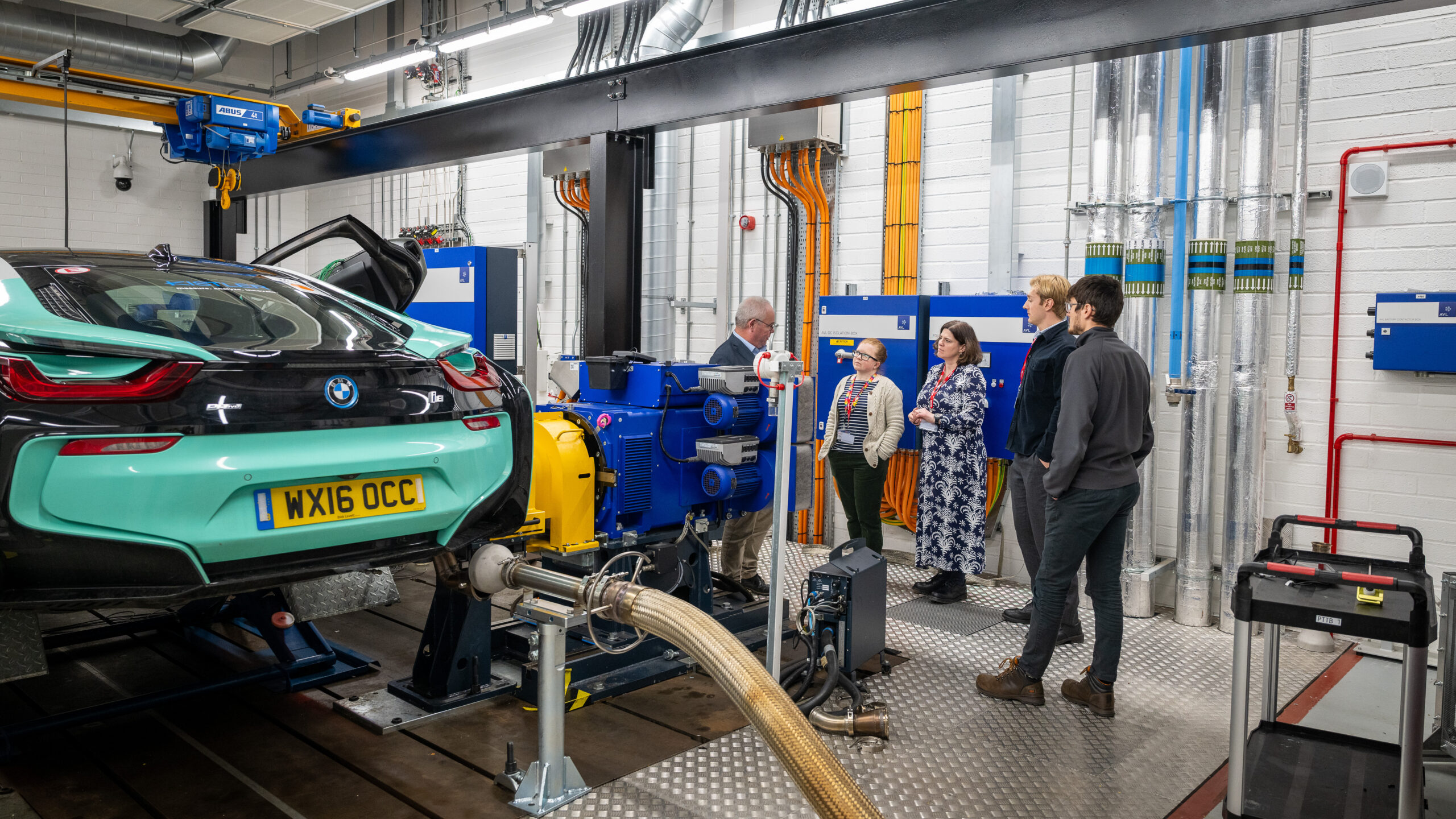 Small group having a tour of IAAPS being shown a test car
