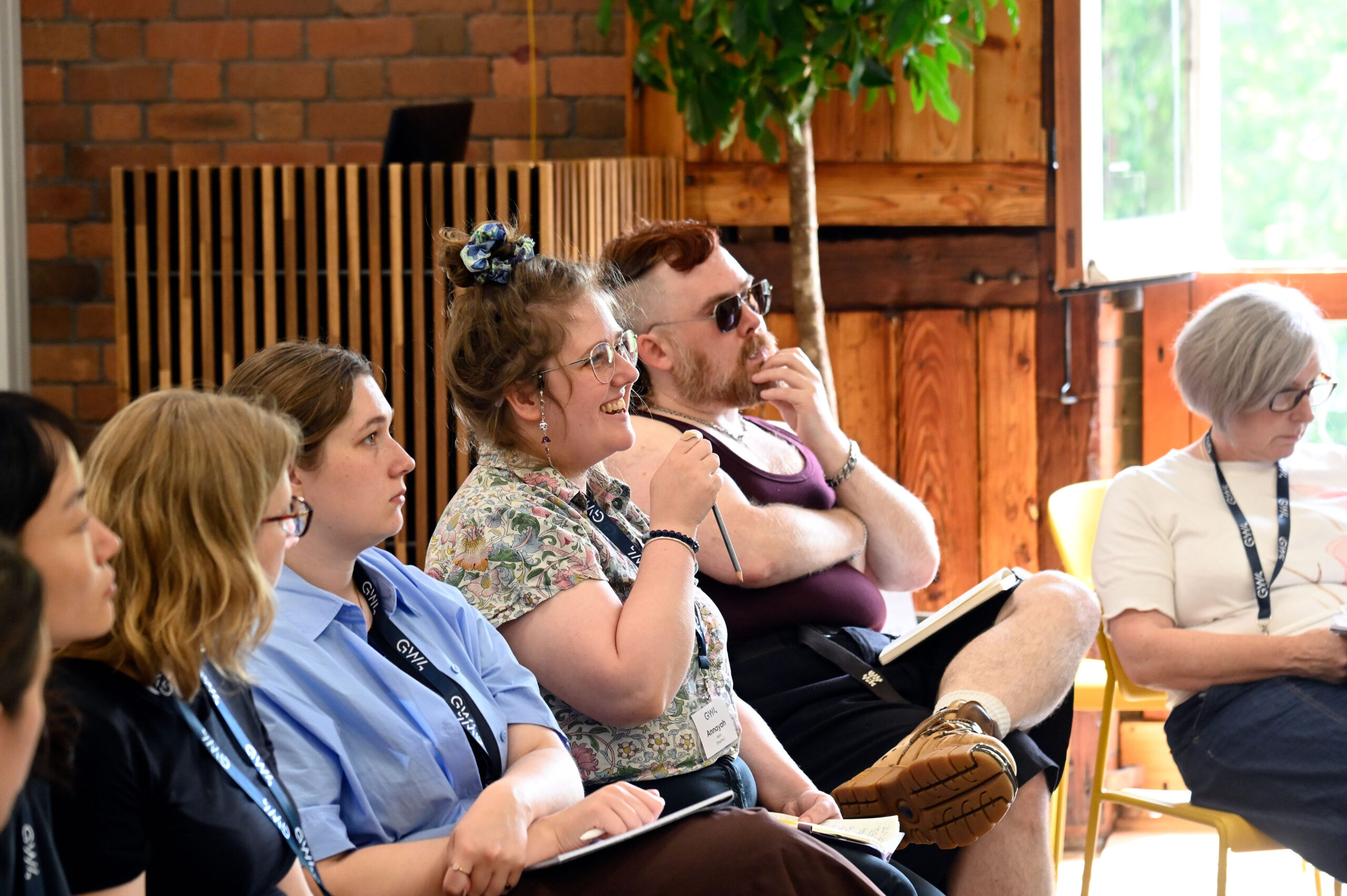 Participants sat in a row listening to the facilitators speak.